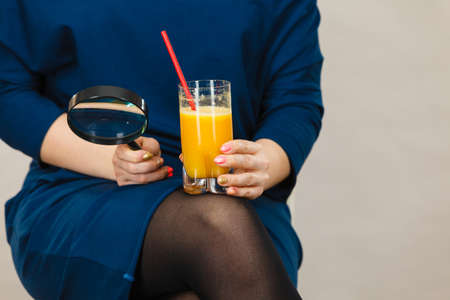 Woman hand holding fresh orange grapefruit juice. Healthy fruit drink smoothies concept.の写真素材
