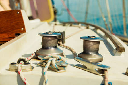 Yacht capstan with rope on sailing boat during cruise, marine objects concept.の写真素材