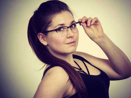 Portrait of happy positive business woman or student girl wearing eyeglasses, enjoying her work, college.の写真素材