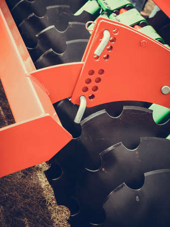 Agriculture equipment concept. Detailed closeup of disc harrow, agricultural machinery. Outdoor shot