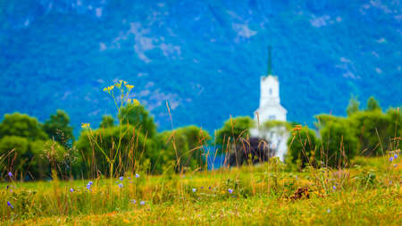 Mountain landscape and the white wooden Oppstryn Church in Stryn Municipality in Sogn og Fjordane county, Norway.の写真素材
