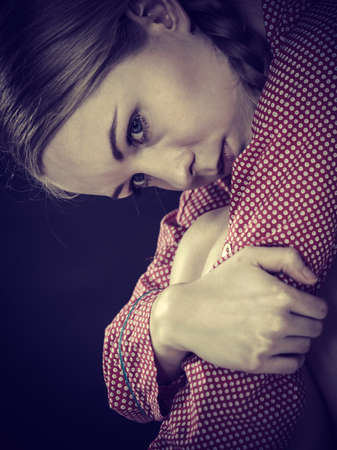 Mental health depression concept. Sad depressive young woman teen blonde girl wearing red pajamas...