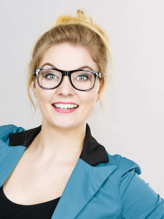 Portrait of happy positive business woman wearing eyeglasses, accountant or teacher, enjoying her work.の写真素材