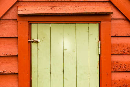 Details in traditional achitecture concept. Big green oldfashioned wooden doors in cottage houseの写真素材