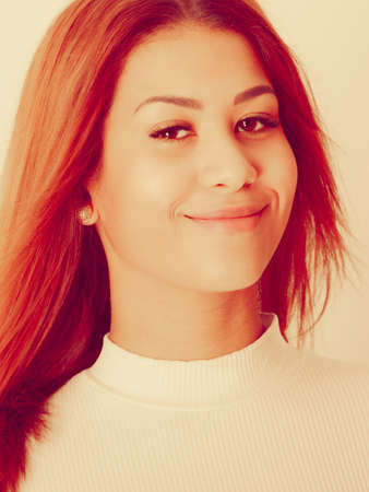 People, fashion concept. Portrait of mulatto lady. Beautiful young woman wearing white top, nice...