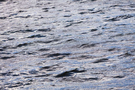 Nature, ocean concept. Closeup of blue sea waving water with small wavesの写真素材