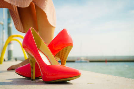 Fashion and footwear. Red high heel classic shoes outdoor during sunny day.の写真素材