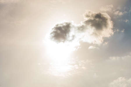 Weather forecast concept. Closeup of small dark rainy clouds on bright, sunny sky.の写真素材