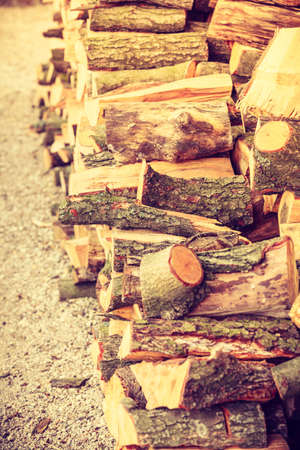 Firewood, home heating concept. Pile of cutted wood standing outside, outdoor shot.