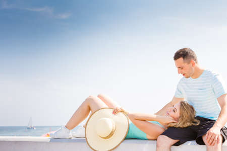 Relationship goals, outdoor relaxation, love and friendship concept. Man and woman sitting together outside hugging, having date.の写真素材