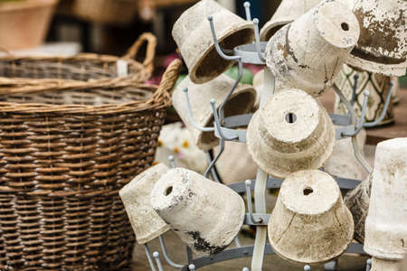 Vintage decorations, antique design objects concept. Old fashioned ceramic clay vases pots on hangerの写真素材