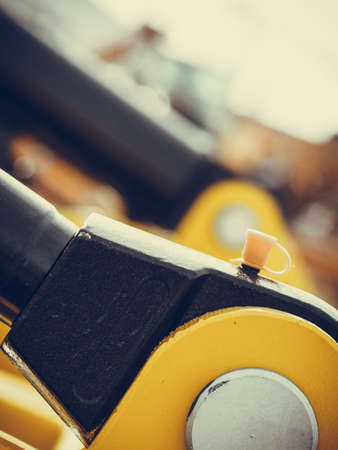 Industrial detailed pneumatic, hydraulic machinery concept. Pump made of steel on orange machine closeup.の写真素材