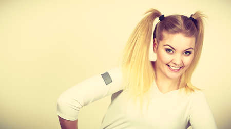 Education, teenage adolescence, happiness concept. Happy blonde teenager student girl with ponytailsの写真素材