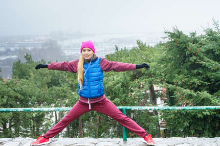 Outdoor sport exercises, sporty outfit ideas. Woman wearing warm sportswear training exercising...