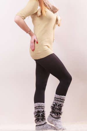 Winter fashion. Woman legs in black pantyhose and stylish fashionable woolen warm socksの写真素材