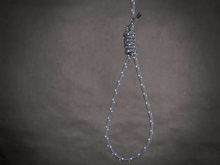 Suicide rope with knot on black background. Sorrow, psychological problems objects concept.の写真素材