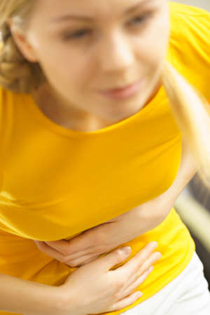 Health care concept. Bellyache, indigestion or menstruation. Young female suffering from strong...