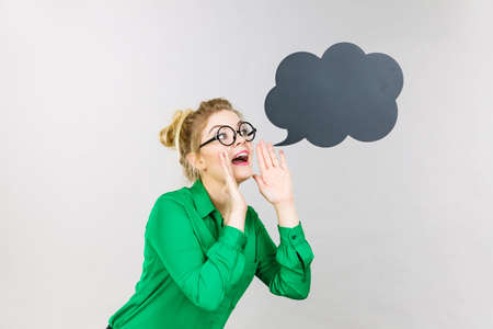 Business woman wearing green shirt and eyeglasses yelling telling something someone, black thinking...