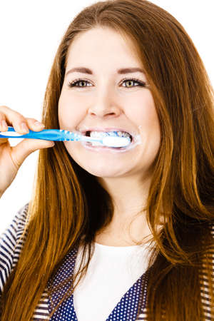 Woman wearing dressing gown brushing cleaning teeth. Funny girl with toothbrush. Oral hygiene. Isolated on whiteのeditorial素材