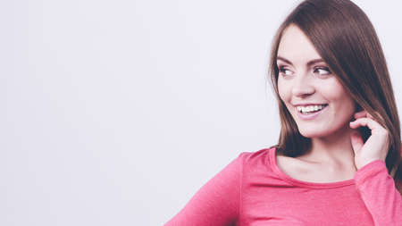 Young woman with brown hair looking with joyの写真素材