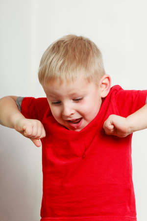Face expressions, children concept. Portrait of happy kid boy making funny silly facesの写真素材