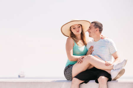 Relationship goals, love and friendship concept. Man and woman sitting together outside hugging, having date.の写真素材