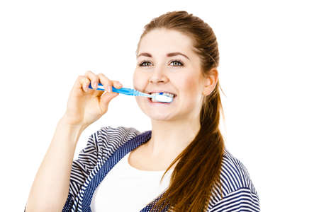 Woman wearing dressing gown brushing cleaning teeth. Funny girl with toothbrush. Oral hygiene....