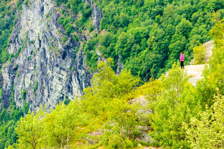 Tourism vacation and travel. Tourist woman enjoying mountains landscape at summer in Norway, Scandinavia.の写真素材