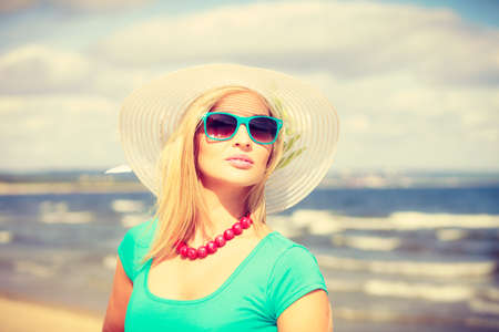 Clothes people summer concept. Pretty woman wearing nice clothing. Lady has turquoise top and white dress.の写真素材