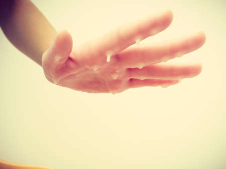 Handcare, beauty studio wellness treatments concept. Woman getting paraffin hand treatment at spa salon.の写真素材