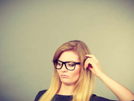Intellectual expressions, being focused concept. Closeup of attractive woman thinking face expressionの写真素材