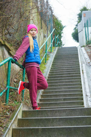 Outdoor sport exercises, sporty outfit ideas. Woman wearing warm sportswear training exercising outside during autumn.の写真素材
