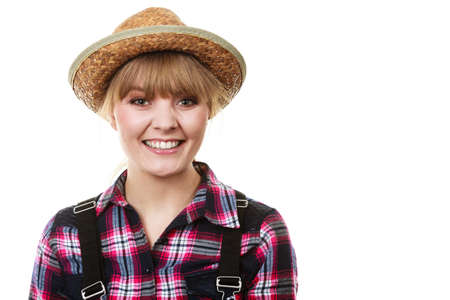 Summer clothing concept. Happy cheerful looking gardener woman in sun hat smilingの写真素材