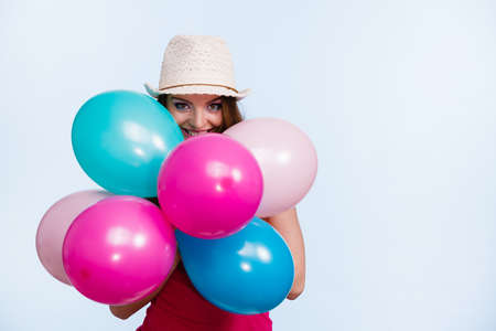 Woman charming girl playing with many colorful balloons. Summer, celebration happiness and lifestyle...