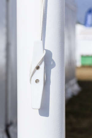 Sailing equipment, textile concept. Detailed closeup of rope on white plastic rook