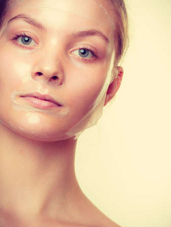 Young woman in facial peel off mask. Peeling. Beauty and skin care. Studio shot toned imageのeditorial素材