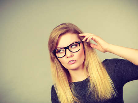 Intellectual expressions, being focused concept. Closeup of attractive woman thinking face expressionの写真素材