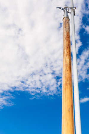 Boat hook on sailboat deck yacht, outdoor shot on blue sky background.