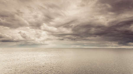 Minimalist idyllic shot of horizontal sea water and sky during cloudy day. Beauty of nature concept.の写真素材