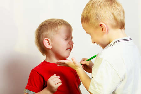 Childhood, relationship between brothers concept. Two little boys siblings playing together having fun.の写真素材