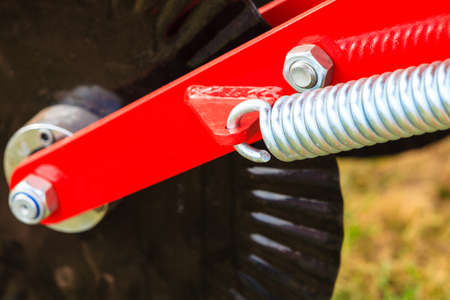 Industrial details, mechanical objects and tools concept. Springs on steel big machinery closeup