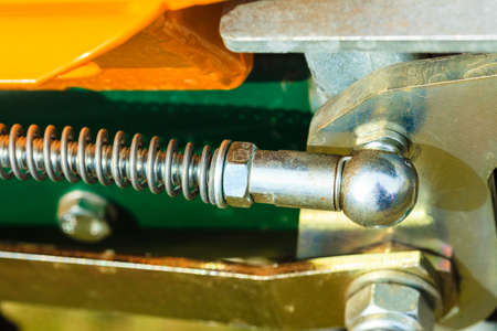 Industrial detailed pneumatic, hydraulic machinery concept. Pump made of steel on orange machine...