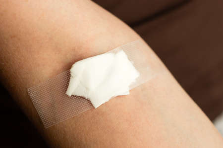 Morphology, vaccines concept. Closeup of bandage on arm after taking blood sampleの写真素材