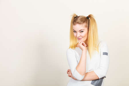 Education, teenage adolescence, happiness concept. Happy blonde teenager student girl with ponytailsの写真素材