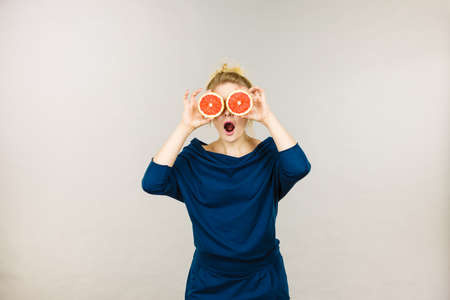 Healthy diet, refreshing food full of vitamins. Woman holding sweet delicious citrus fruit,...