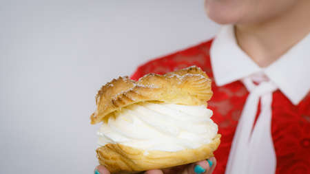 Woman holding sweet cupcake cake dessert with cream, she wants to eat it.の写真素材