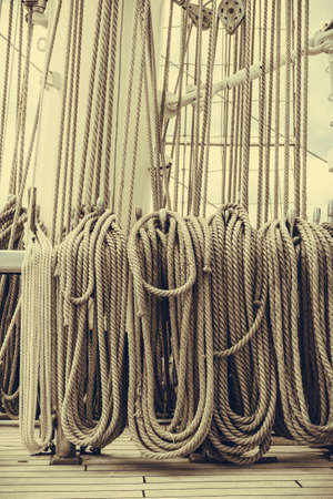 Old fashioned harbor marina sail boat ropes. Yachting details and objects concept.