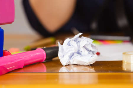Paper ball on desk and pink marker. Office supplies and objects concept.の写真素材