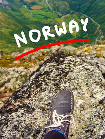 Tourism vacation and travel. Tourist feet on mountain top, view from Dalsnibba viewpoint, Norway...