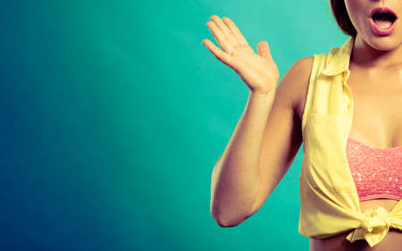 Shock suprise emotions. Suprised and shocked pin up woman. Young lady wearing yellow shirt and pink bra.の写真素材